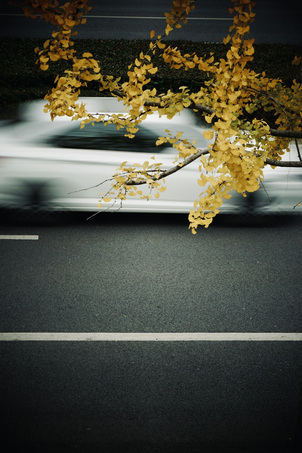 a blurry picture of a car driving down a street