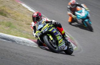 a person riding a motorcycle on a race track