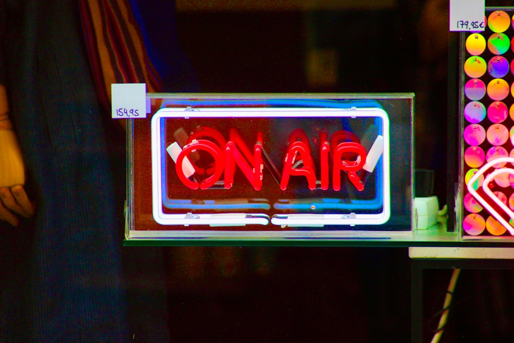a neon sign that says on air on a shelf
