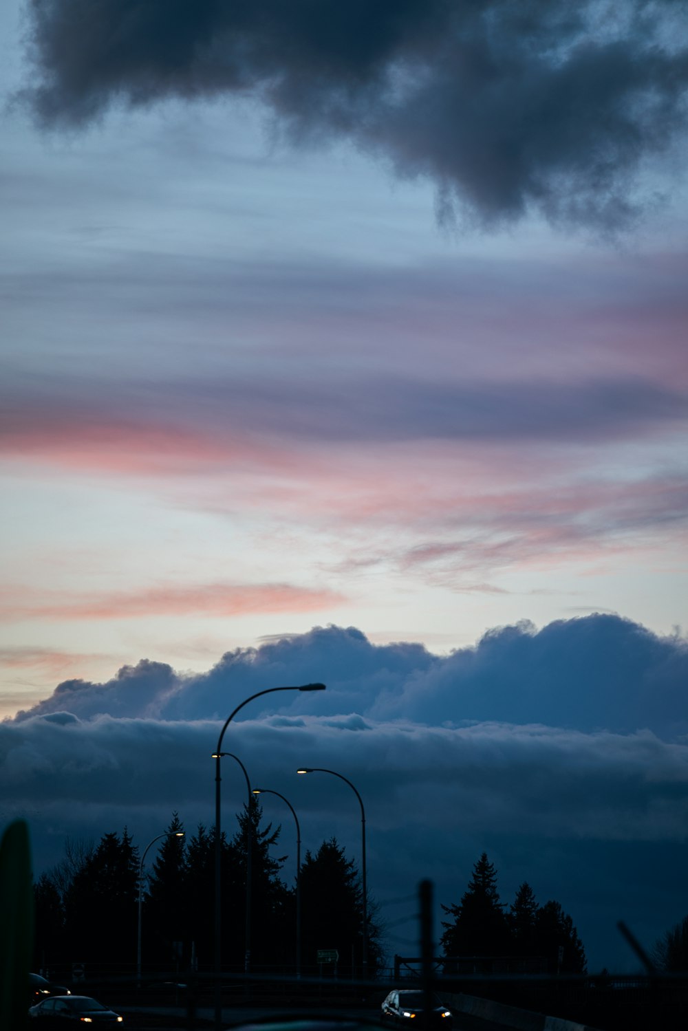 a street light and some clouds in the sky