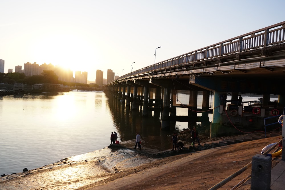 a bridge over a body of water with people standing on it