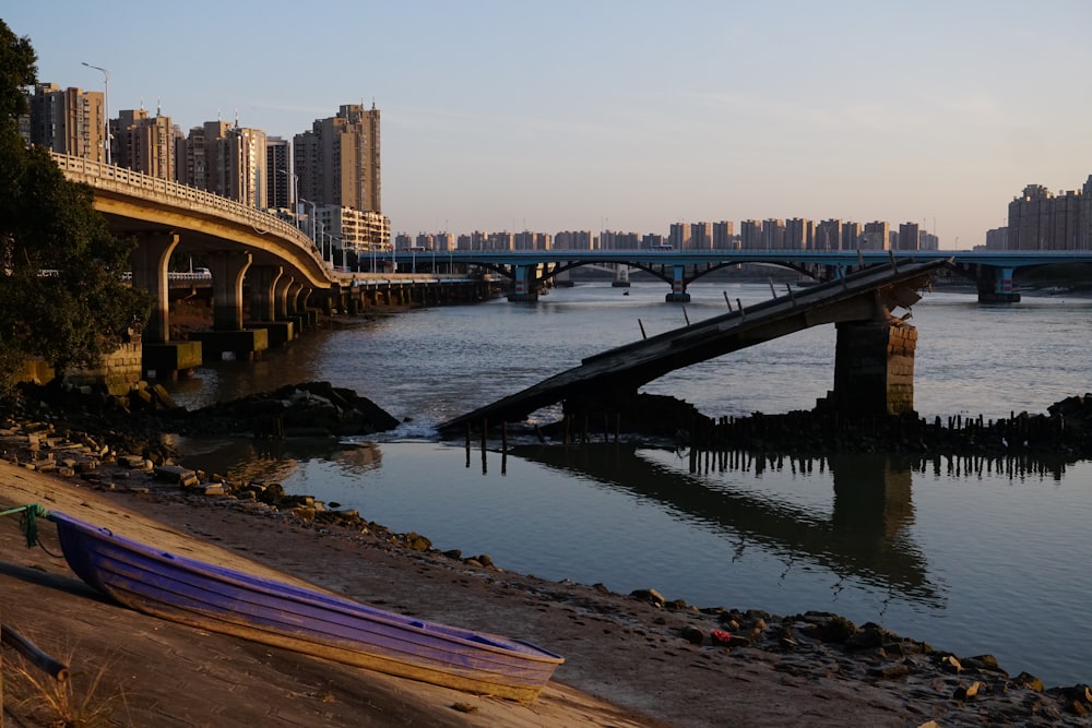 a boat is sitting on the shore of a river