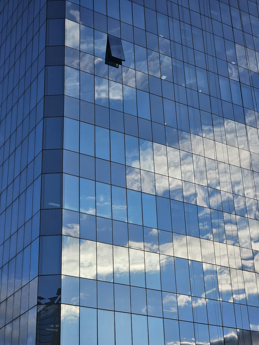 a very tall building with a plane flying in the sky