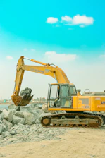 a yellow bulldozer is parked on a beach