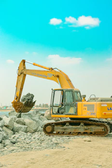 a yellow bulldozer is parked on a beach
