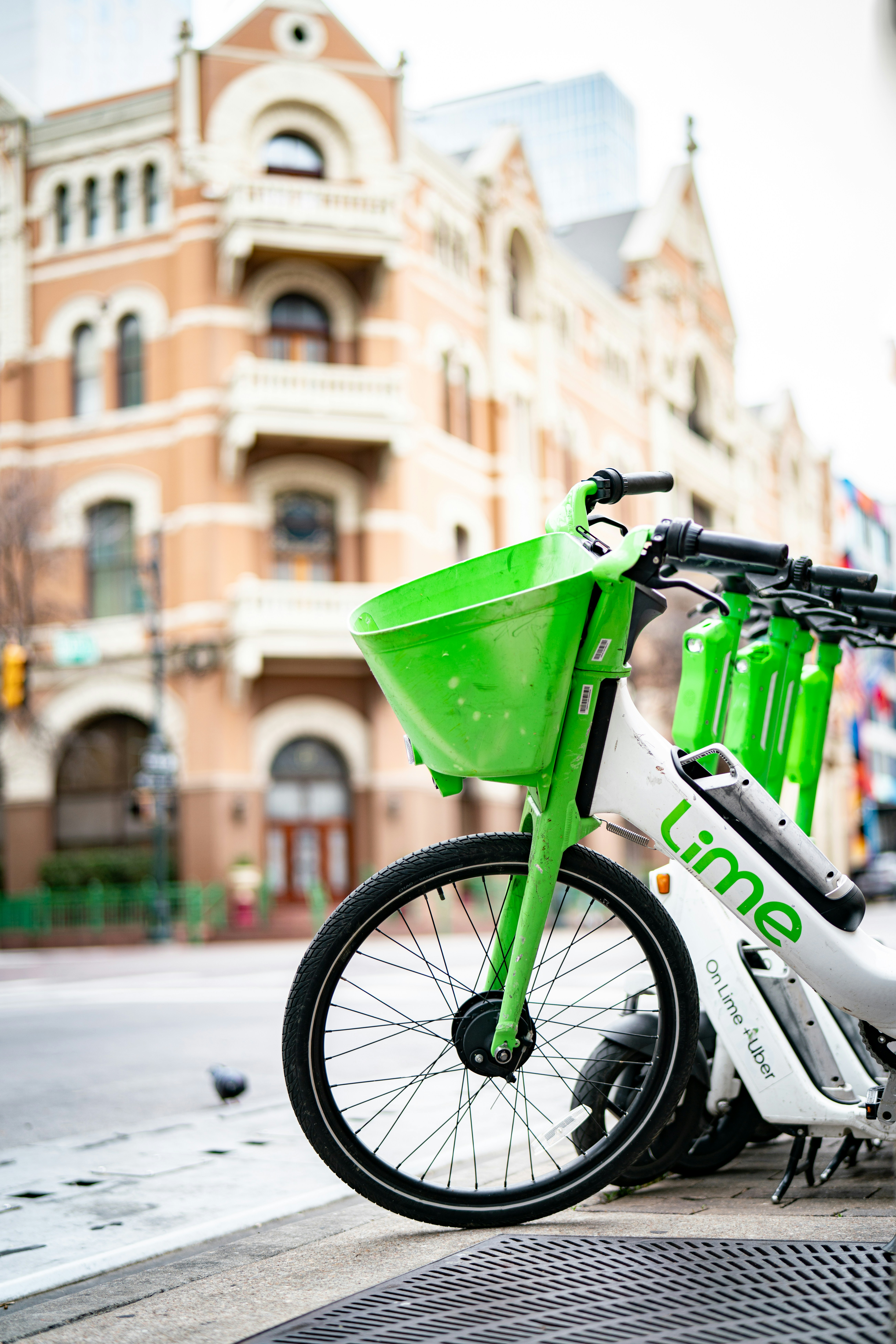 a white and green bike parked on the side of a street