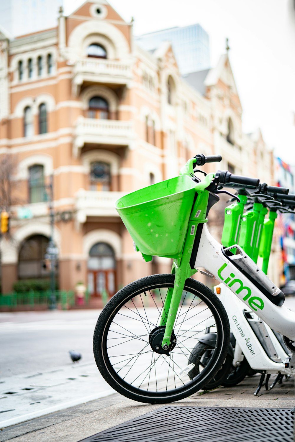 a white and green bike parked on the side of a street