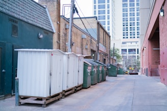 a row of shipping containers sitting on the side of a road
