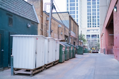 a row of shipping containers sitting on the side of a road