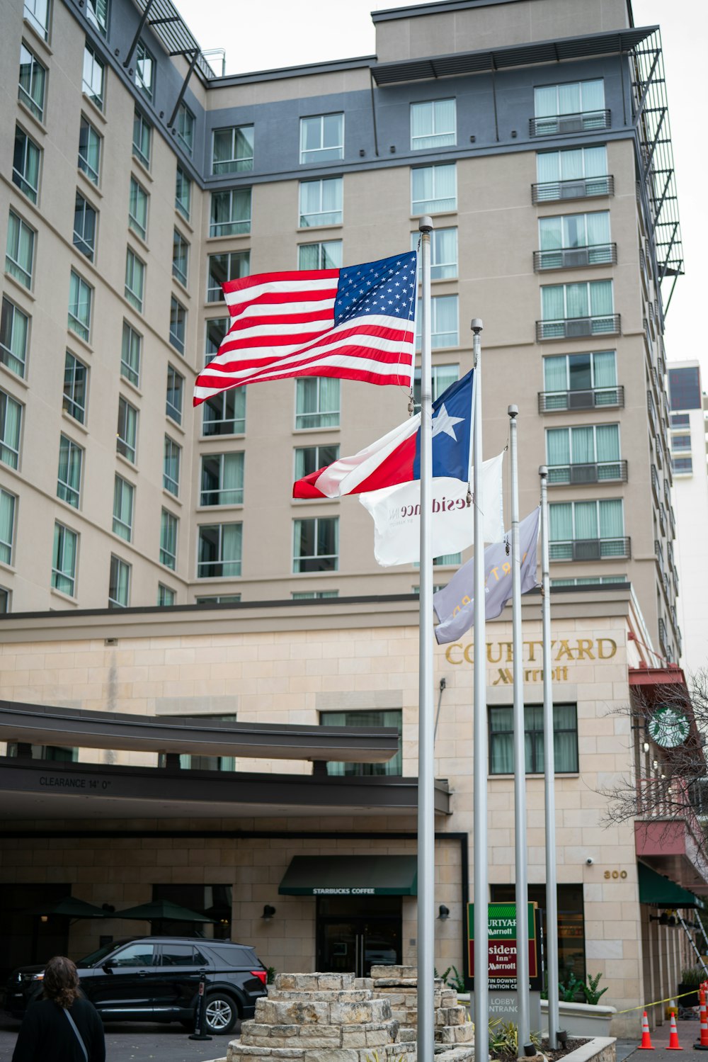 a couple of flags that are in front of a building