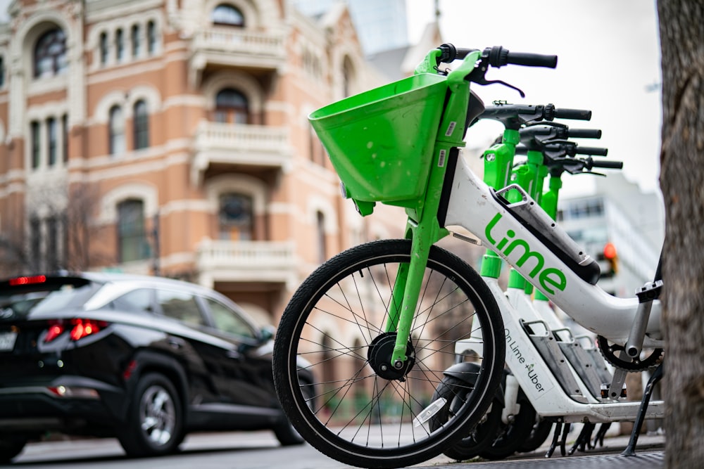 a green bike parked on the side of a street