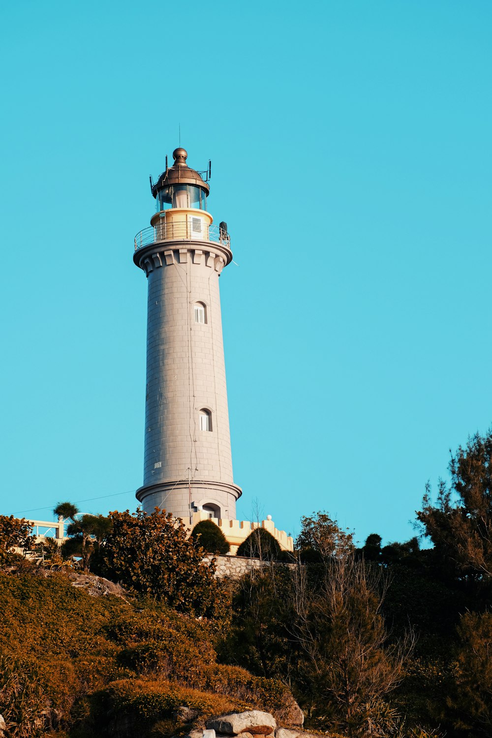 a light house sitting on top of a hill
