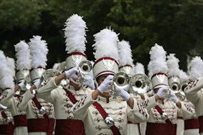 a marching band with white and red uniforms