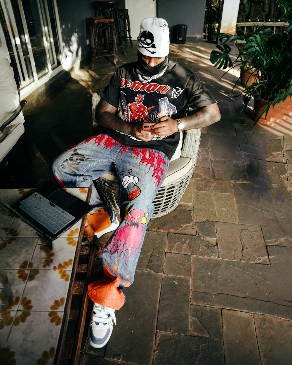 a man sitting on a bench with a skateboard