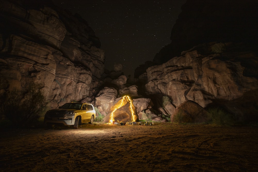 a truck parked in front of a large rock formation