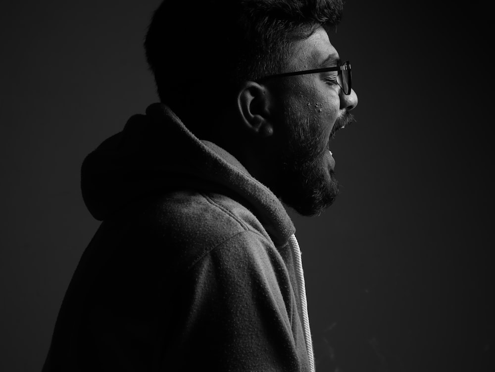 a black and white photo of a man in a hoodie