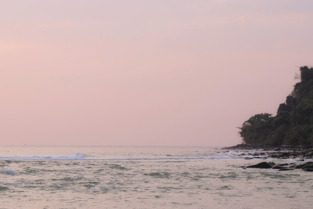 a man riding a surfboard on top of a wave in the ocean