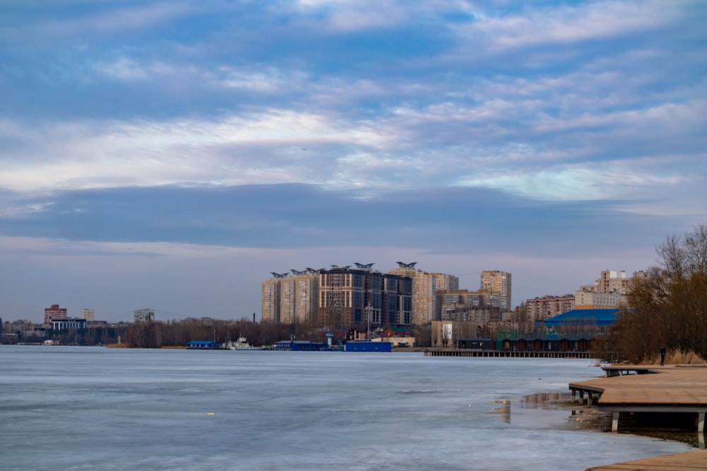 a body of water with buildings in the background