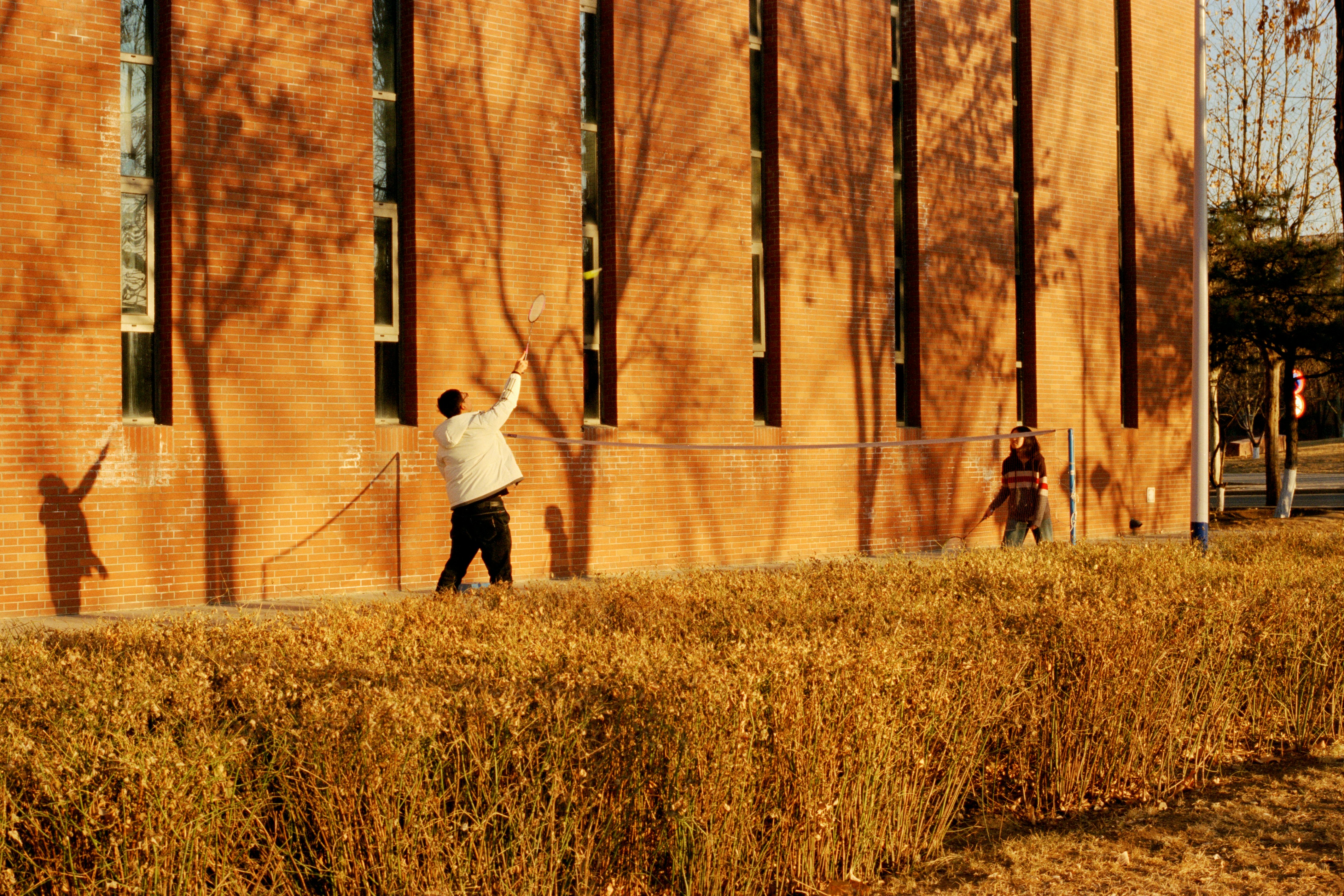 a man holding a tennis racquet on top of a tennis court