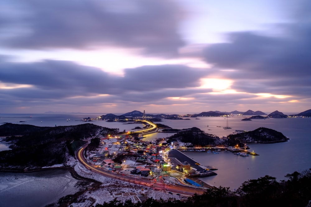 a night time view of a town and a body of water