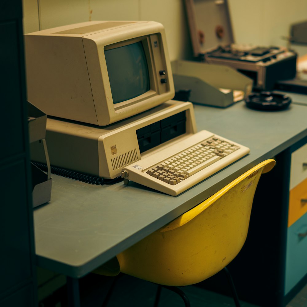 an old computer sitting on top of a desk