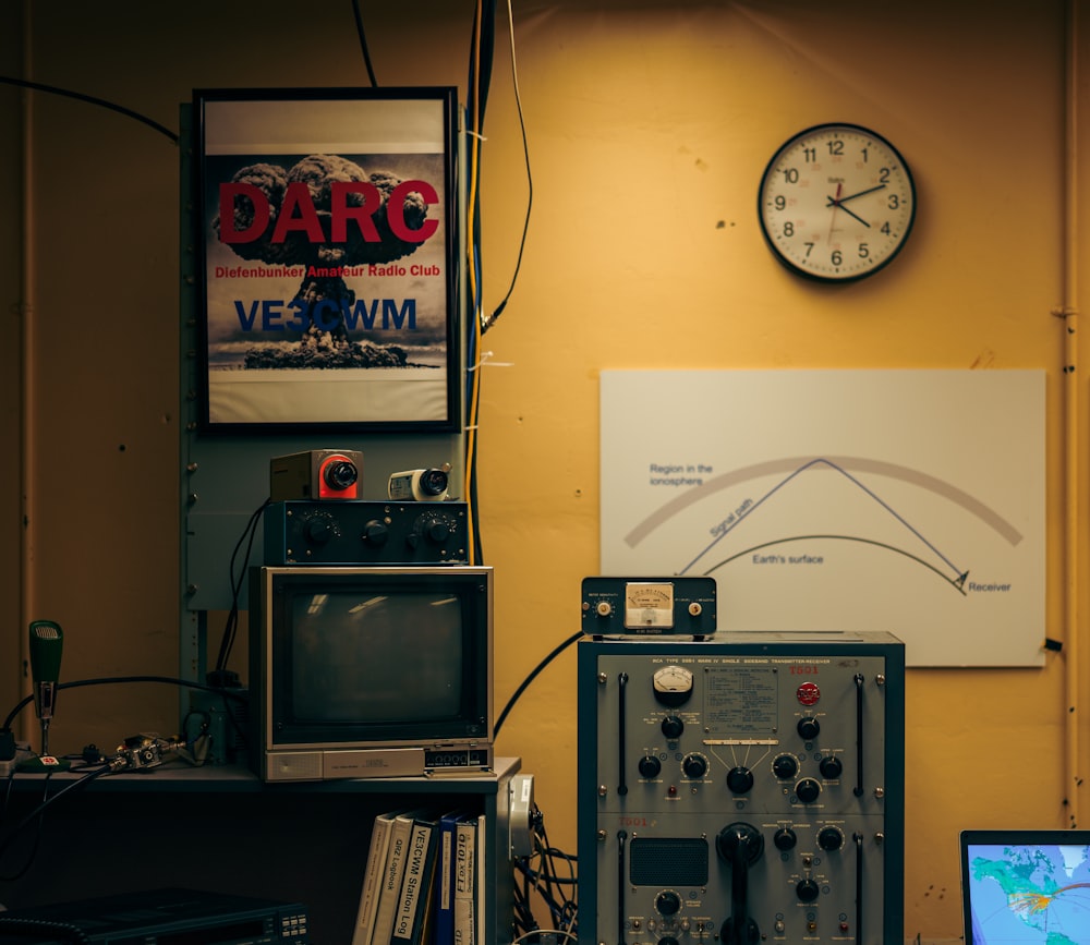 a room filled with electronics and a clock on the wall