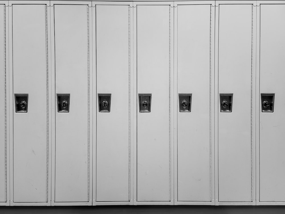 a row of white lockers sitting next to each other