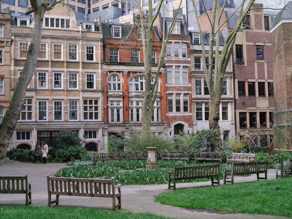 a couple of benches sitting next to each other in a park