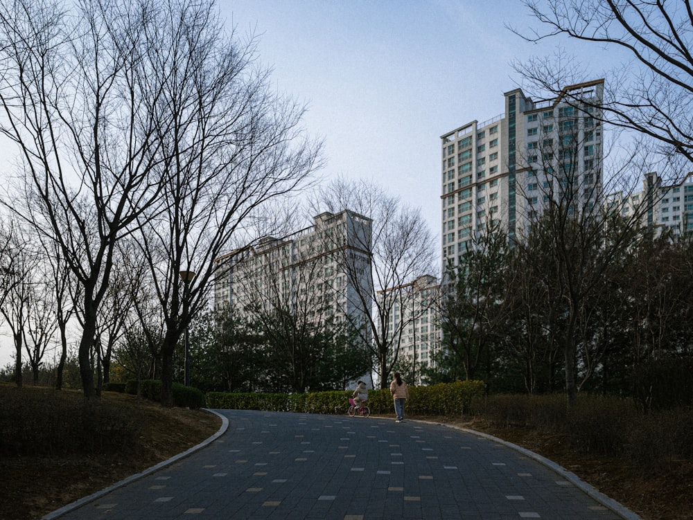 a person riding a skateboard on a paved road