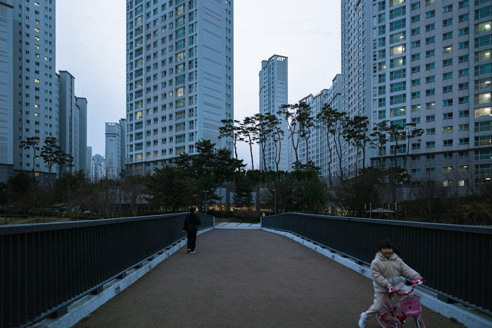 a person riding a bike across a bridge