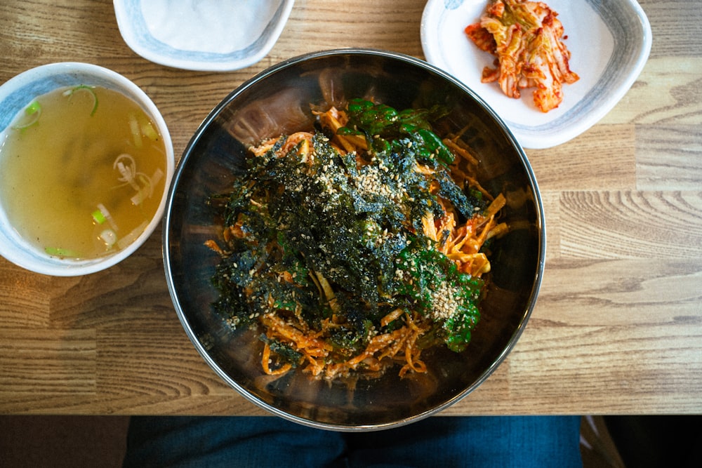 a person sitting at a table with a bowl of food