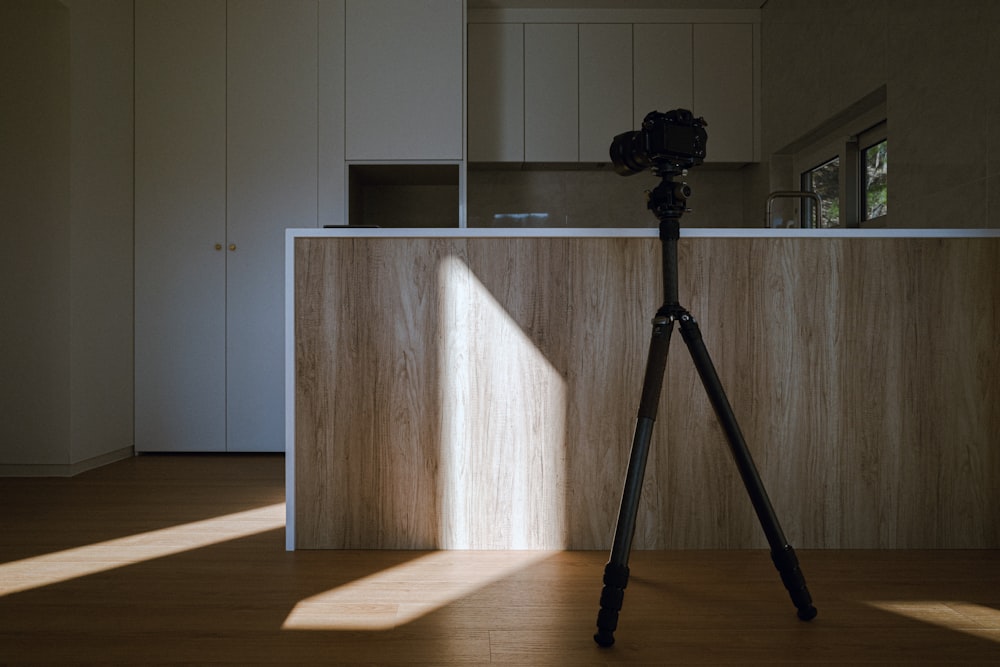 a tripod sitting on top of a hard wood floor