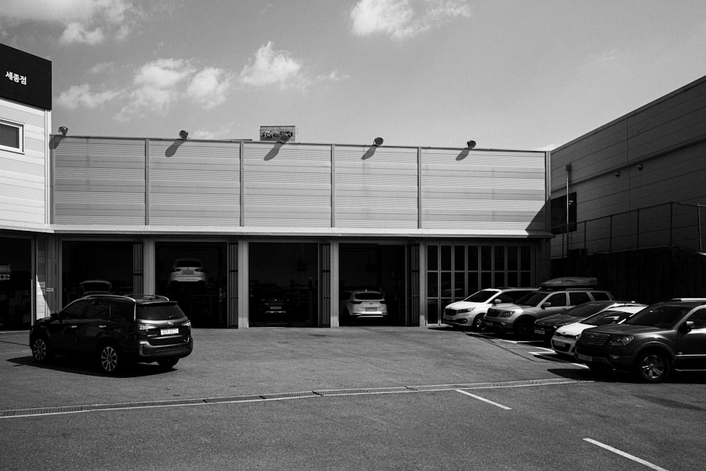 a black and white photo of a car dealership