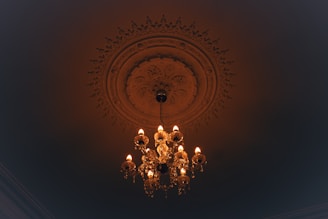 a chandelier hanging from the ceiling in a dark room