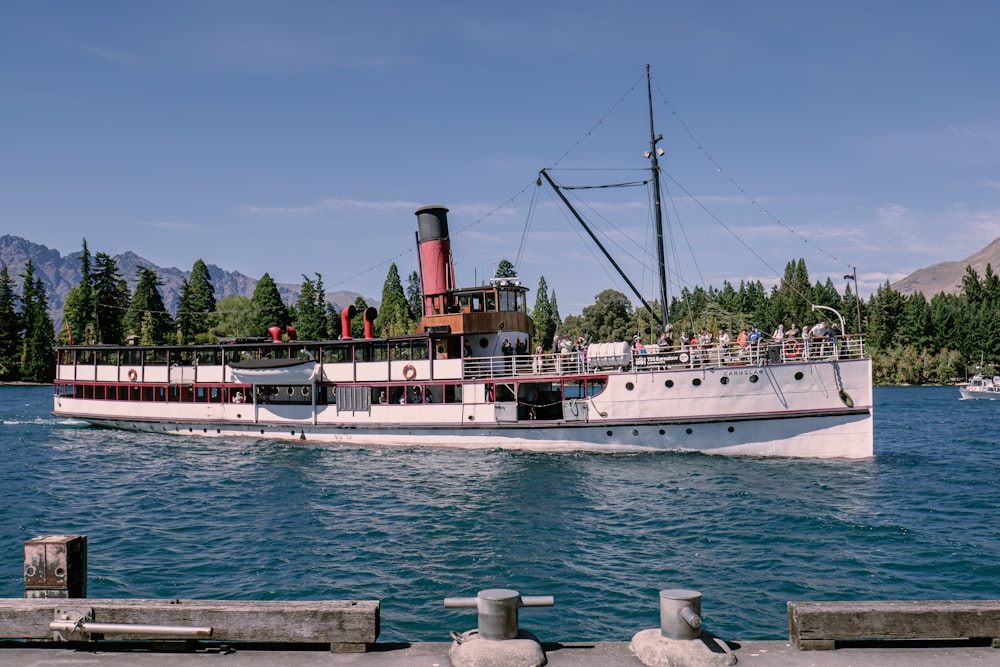 a large white boat floating on top of a body of water