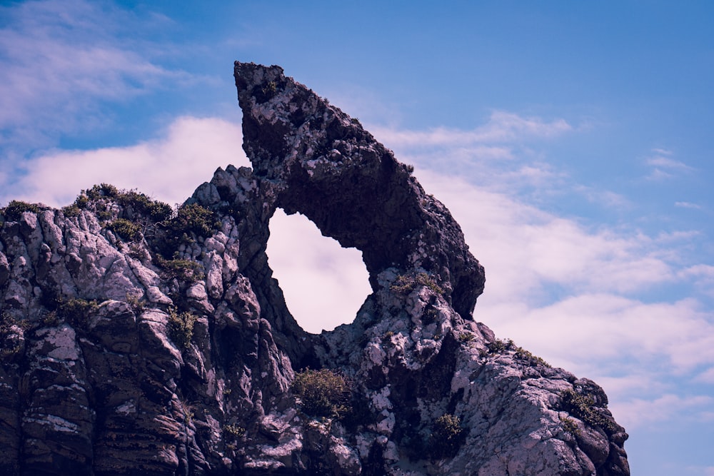 a rock formation with a hole in the middle of it