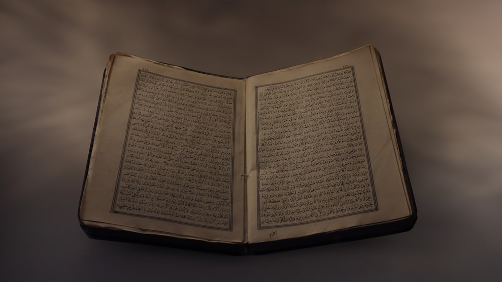 an open book with arabic writing on it