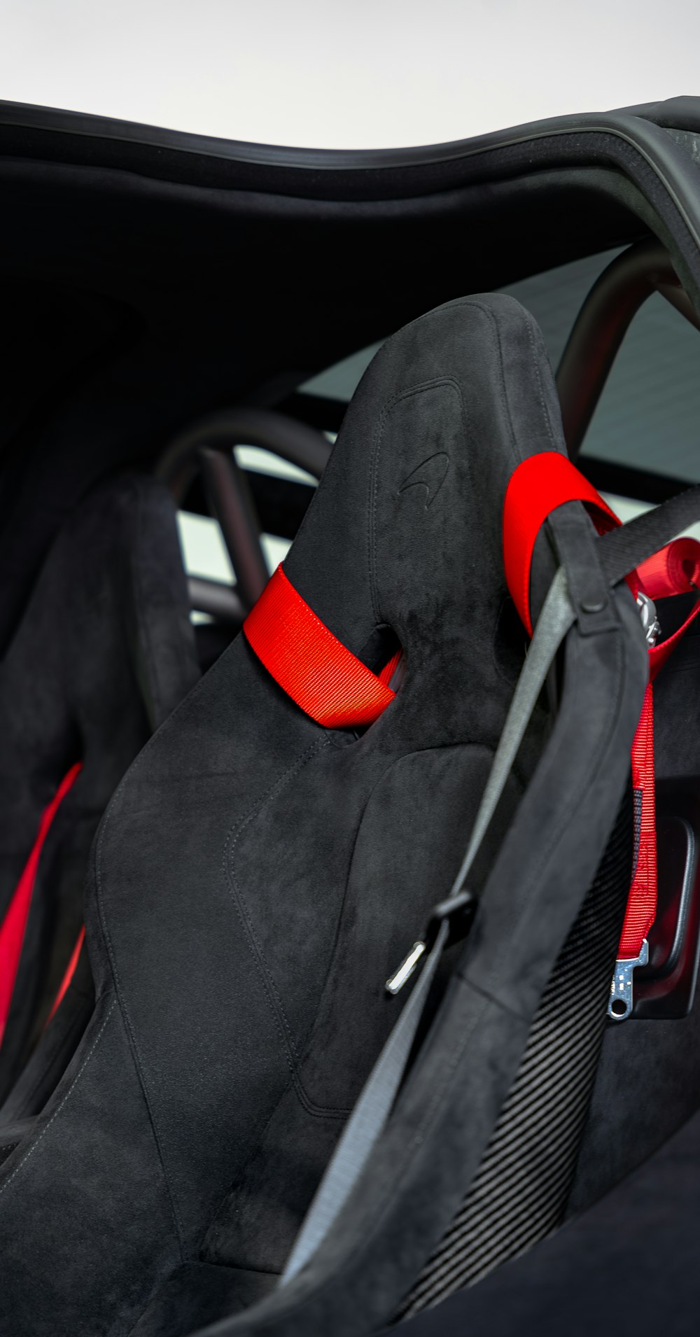 the interior of a sports car with a red seat belt
