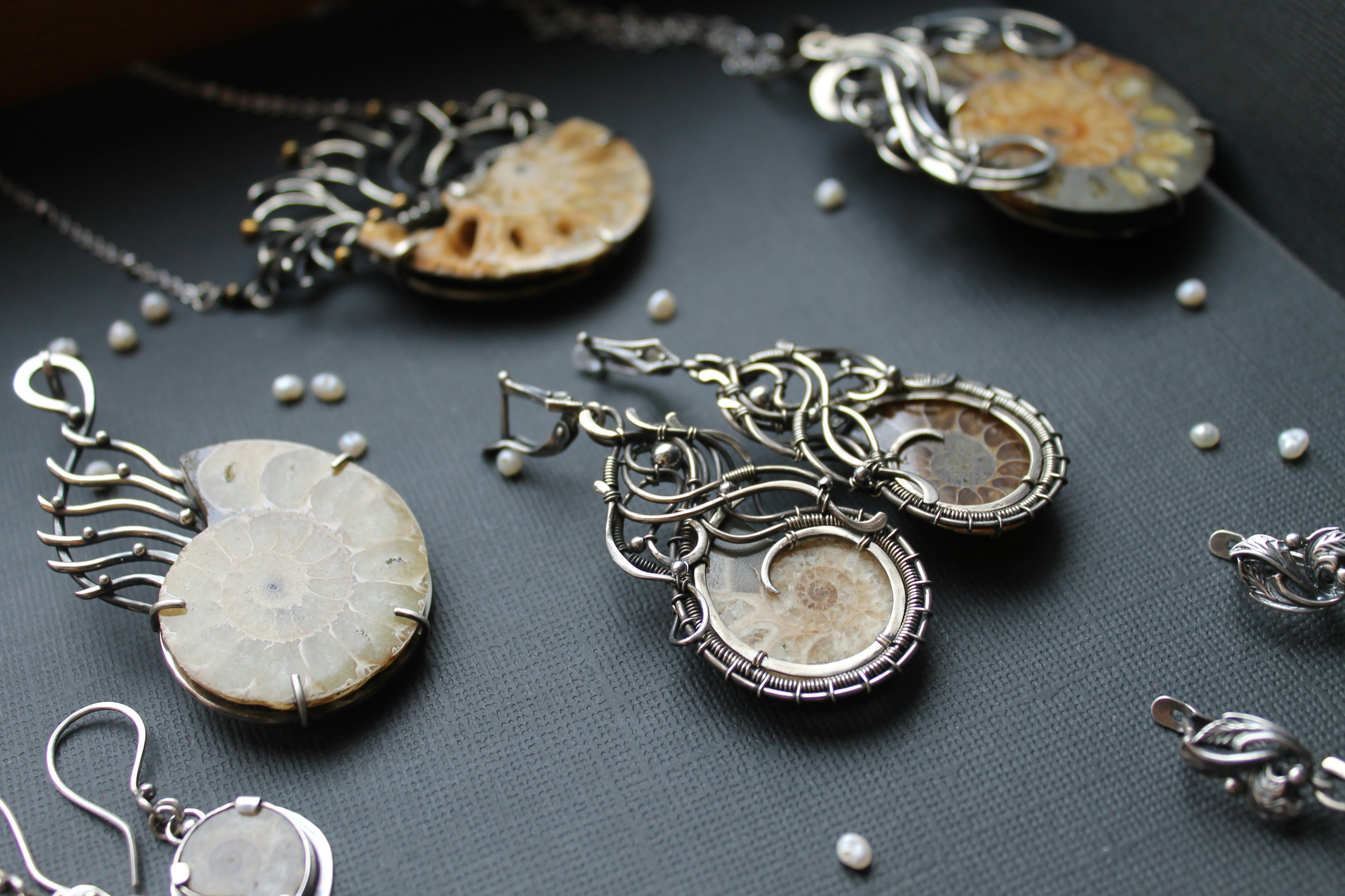 a table topped with lots of different types of jewelry