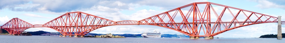 a large red bridge over a large body of water