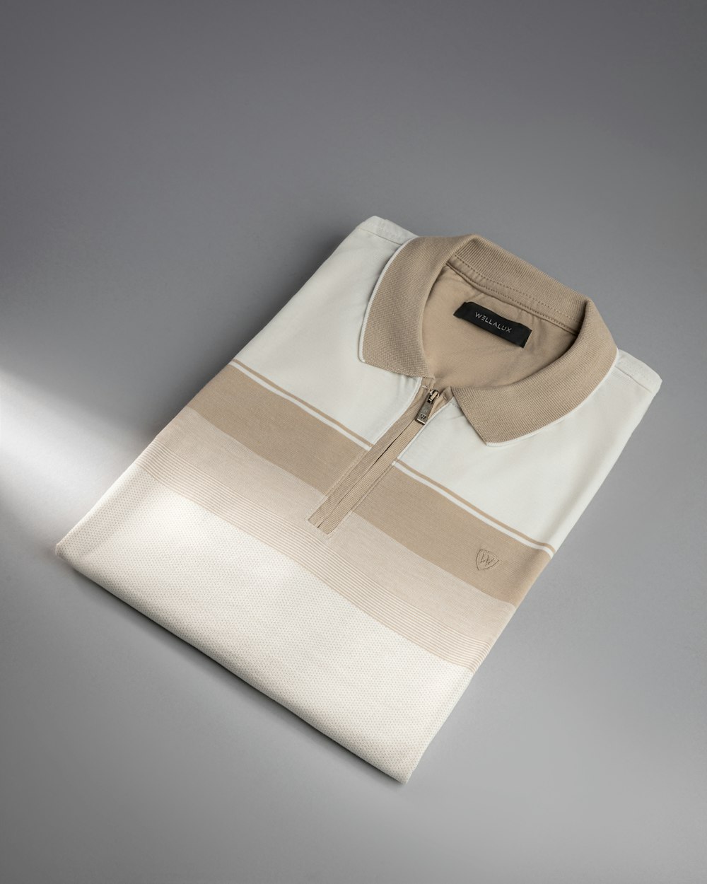 a white and beige shirt with a black collar
