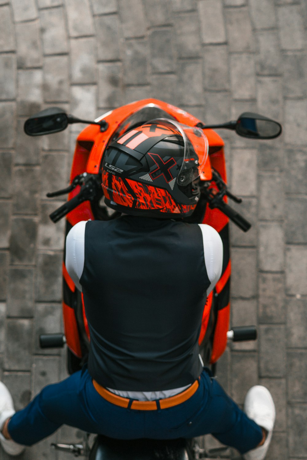a person sitting on a motorcycle with a helmet on
