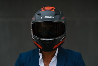 a man wearing a motorcycle helmet and a blue jacket