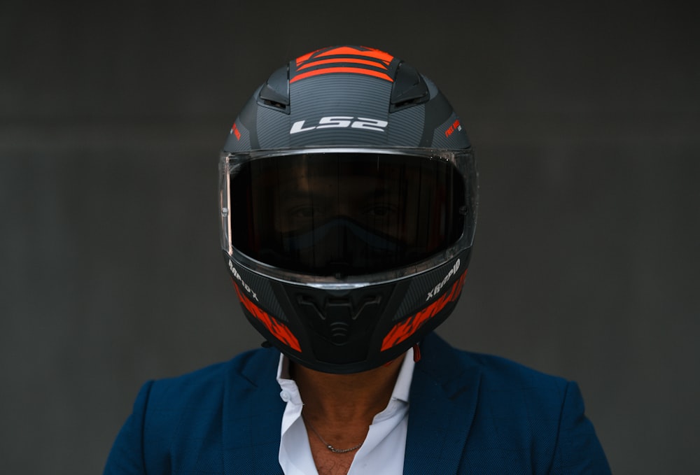 a man wearing a motorcycle helmet and a blue jacket