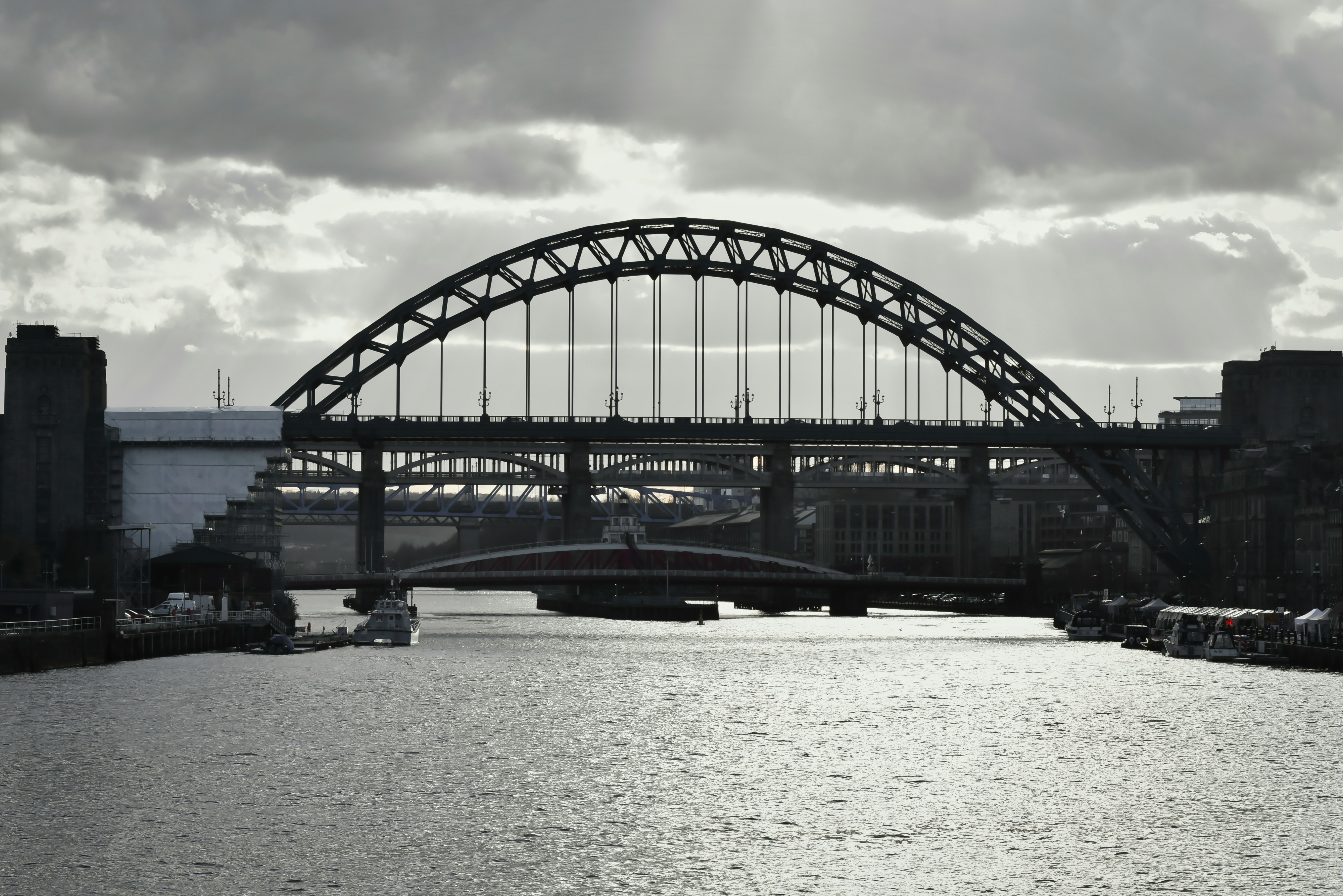 a black and white photo of a bridge over a river