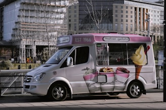 a small ice cream truck parked on the side of the road