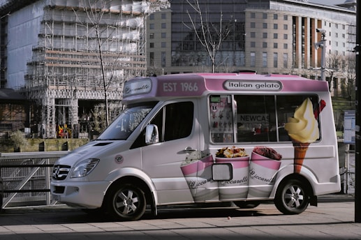 a small ice cream truck parked on the side of the road