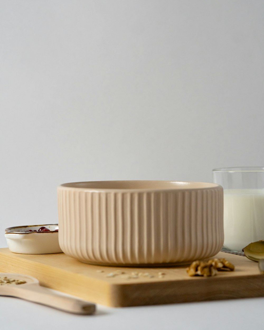 a bowl of oatmeal next to a glass of milk