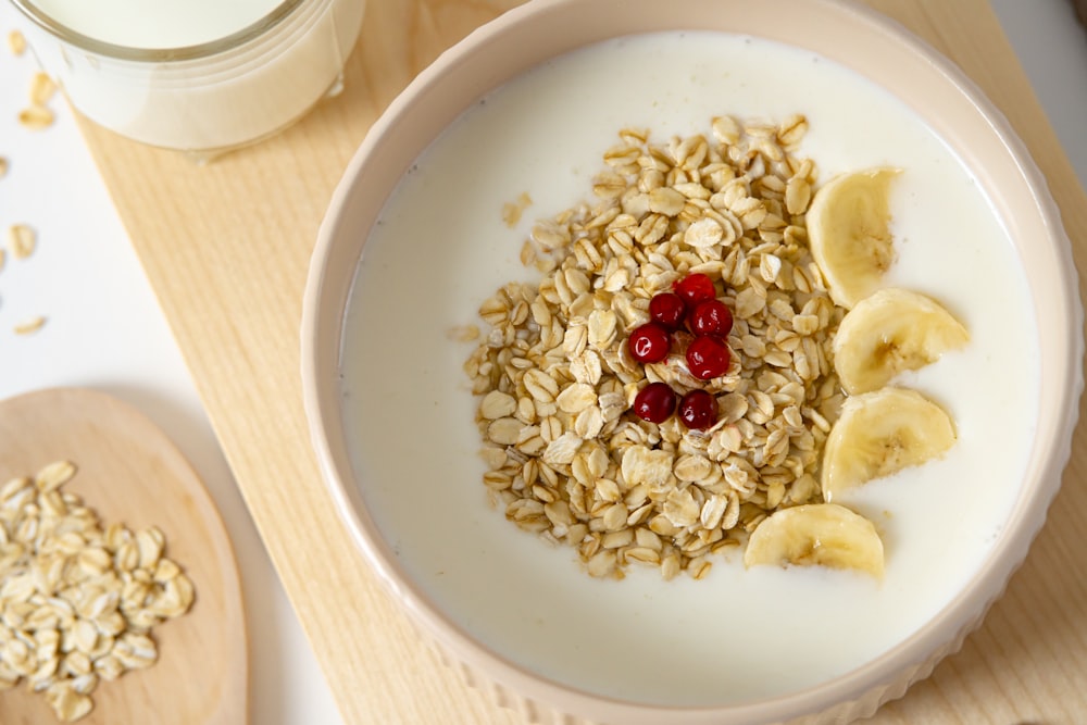 a bowl of oatmeal with bananas and cherries