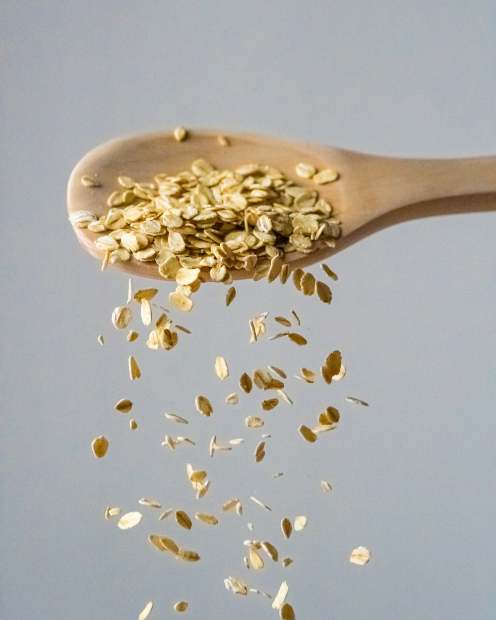 a wooden spoon filled with gold flakes